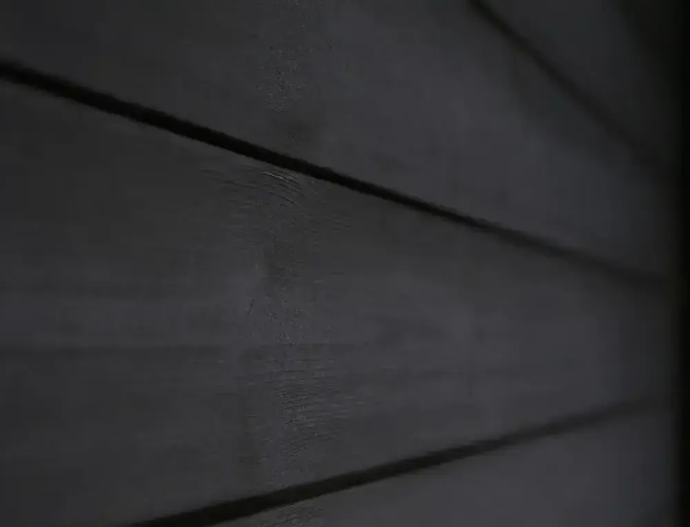 Dark thermally modified timber facade